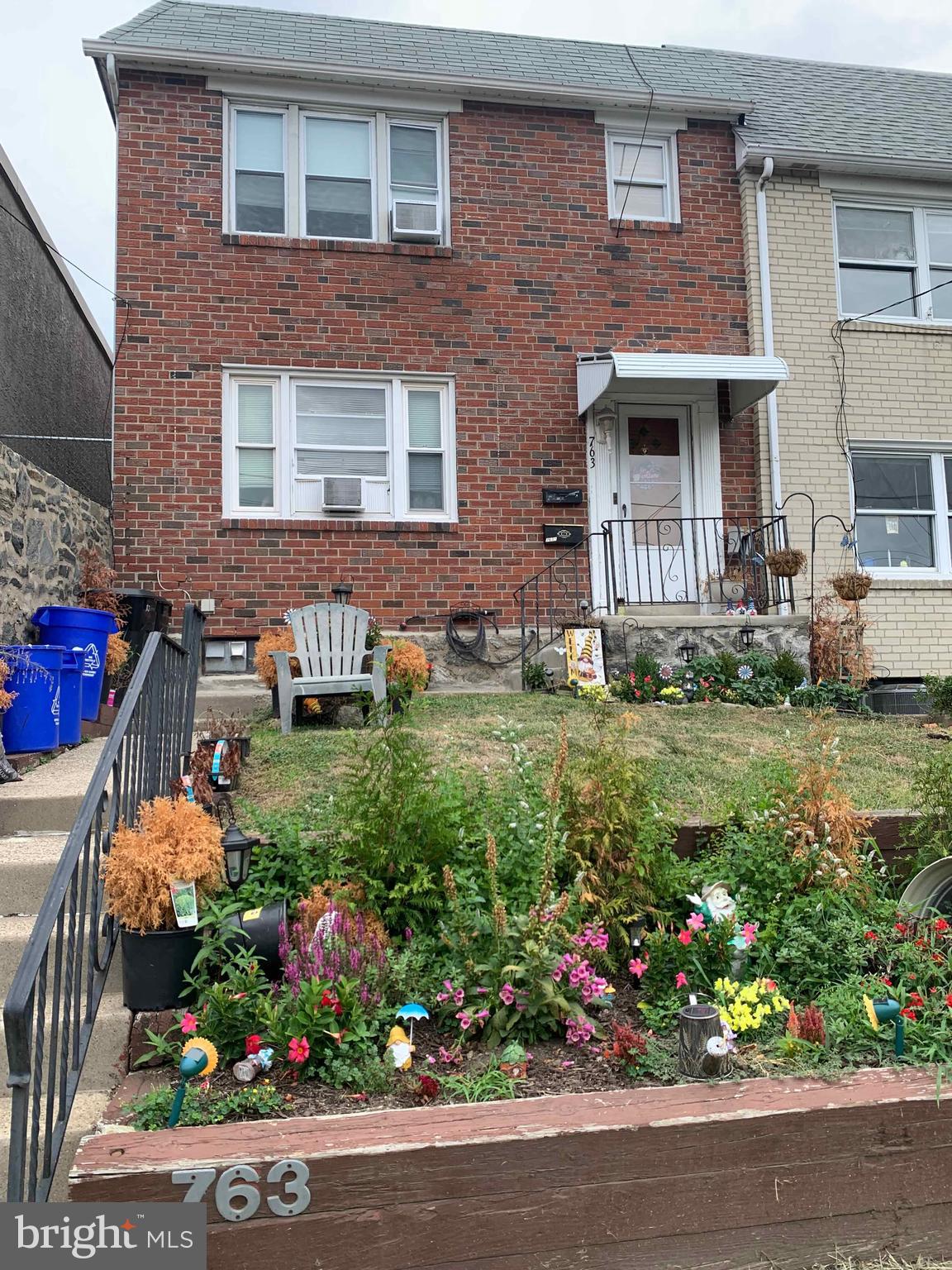 front view of a brick house with a yard