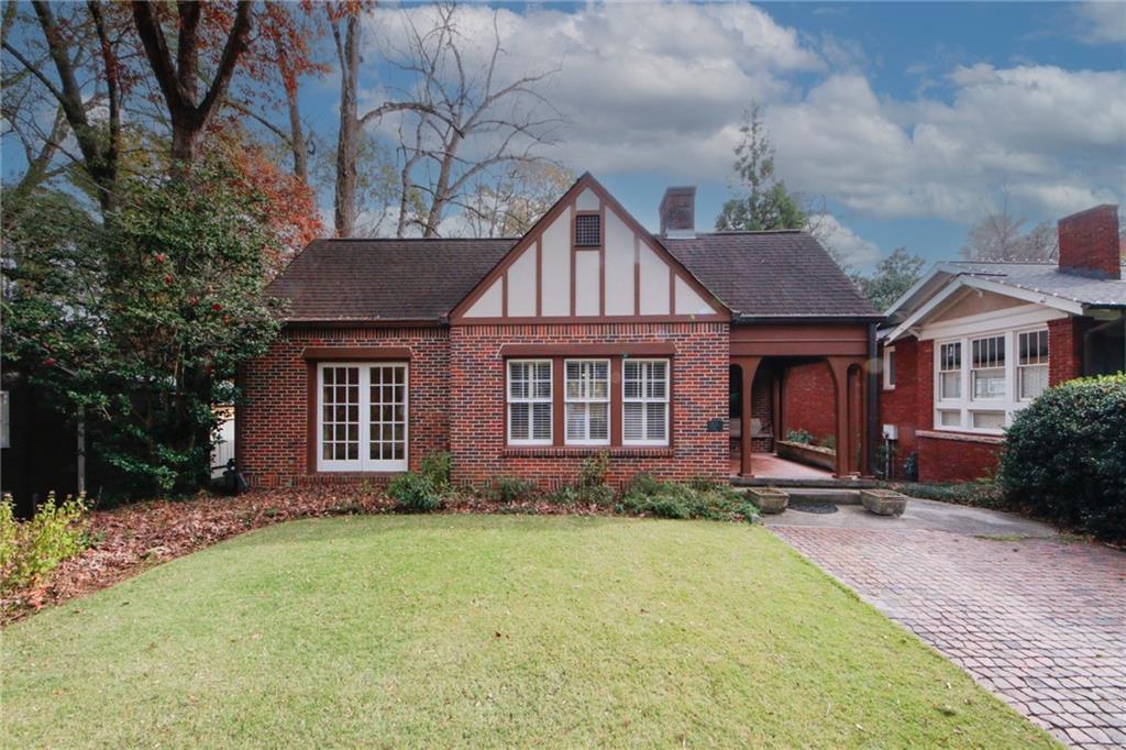 a front view of a house with a yard and trees