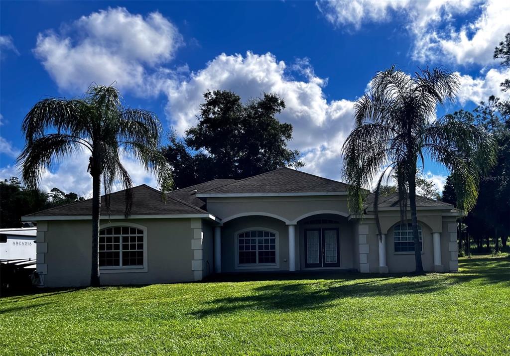 a front view of house with yard and green space