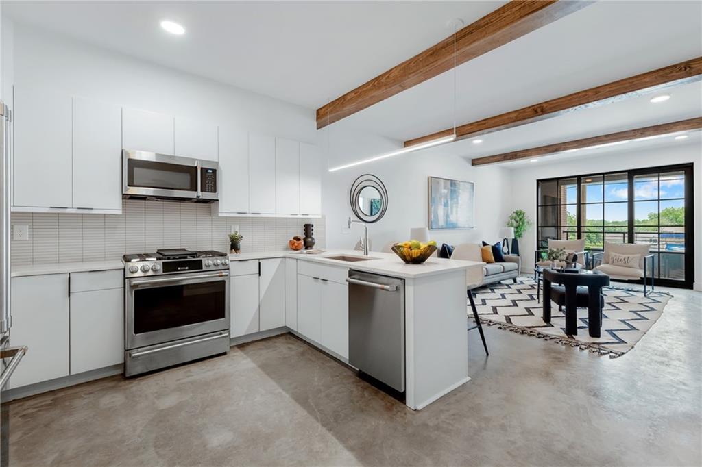 a kitchen with a sink and a stove top oven