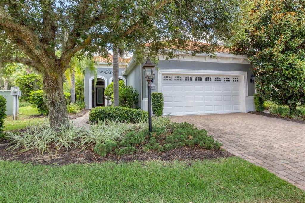 a view of a house with a tree and a yard