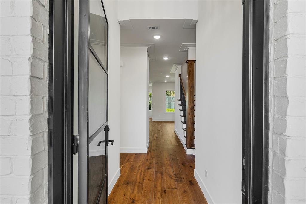 a view of hallway with wooden floor