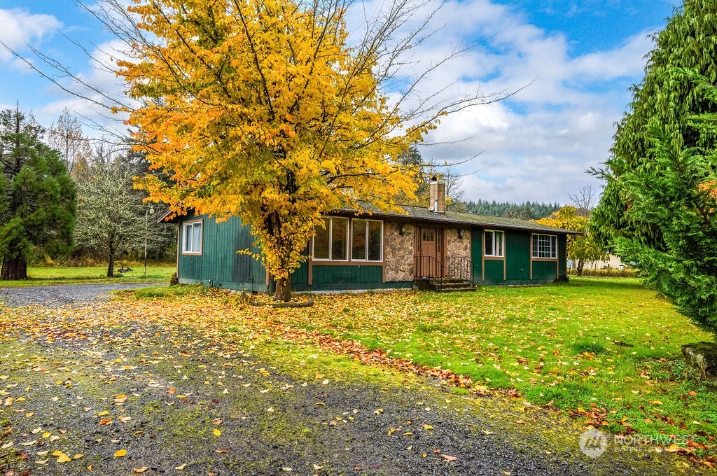 a house that has a tree in front of it