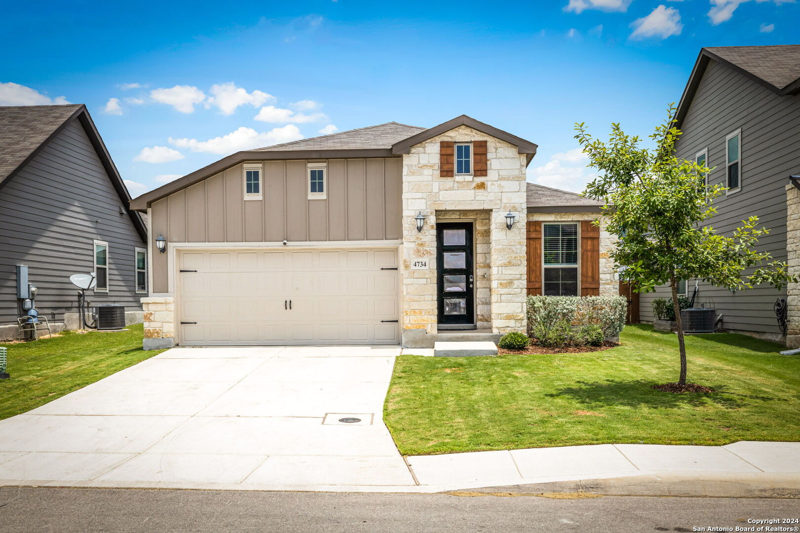 a front view of a house with a yard and garage