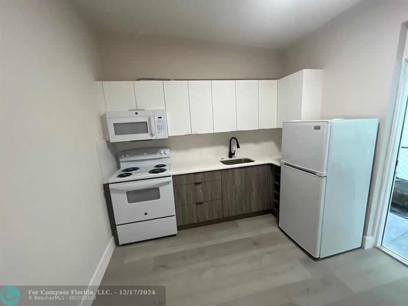 a kitchen with a white cabinets and white appliances