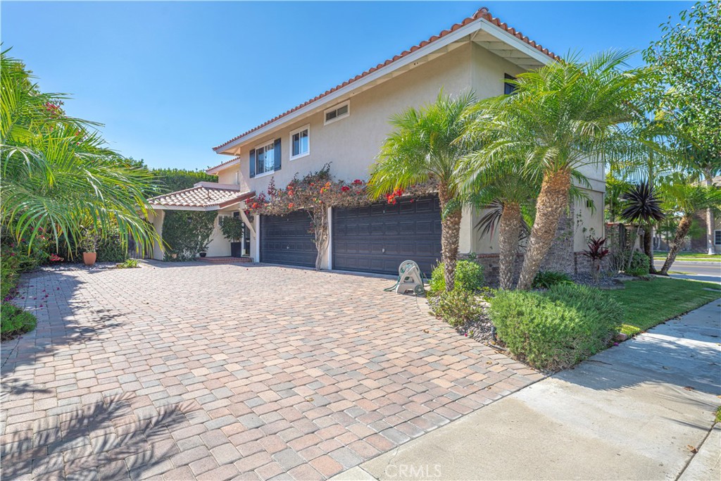 a front view of a house with a yard and a garage