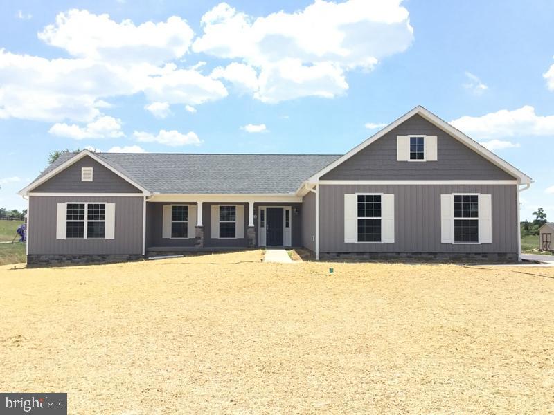 a front view of a house with yard and garage