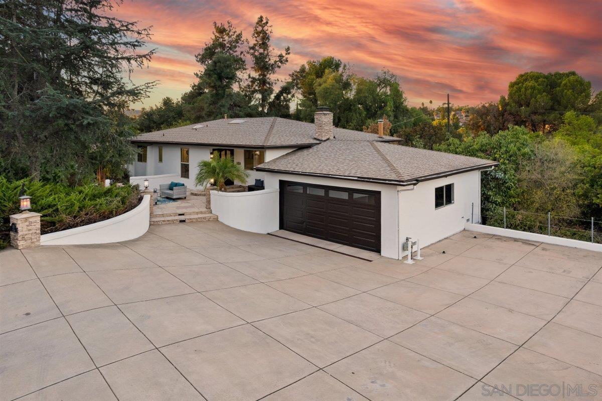 a aerial view of a house with yard and mountain view in back