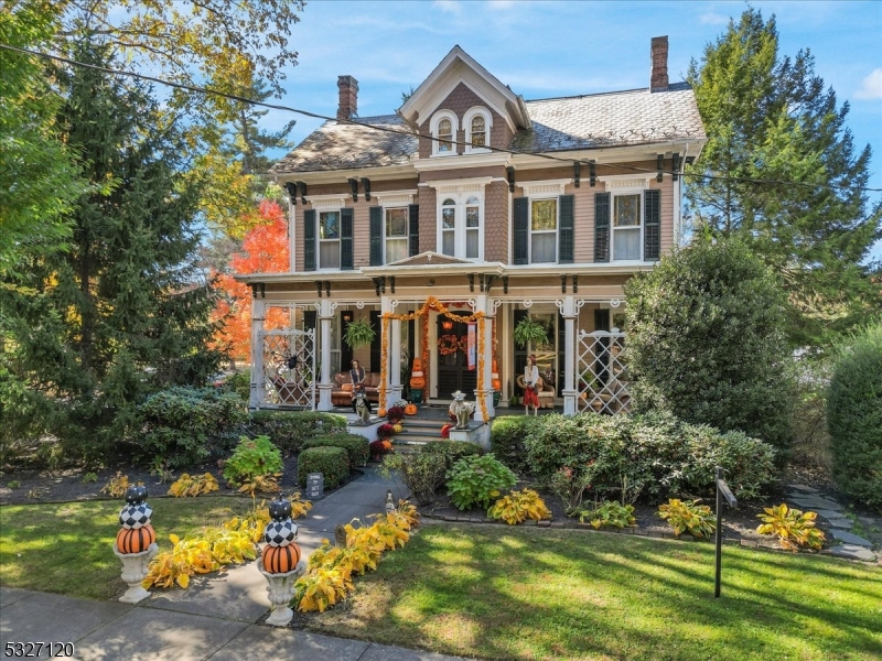 a front view of a house with a yard swimming pool and outdoor seating