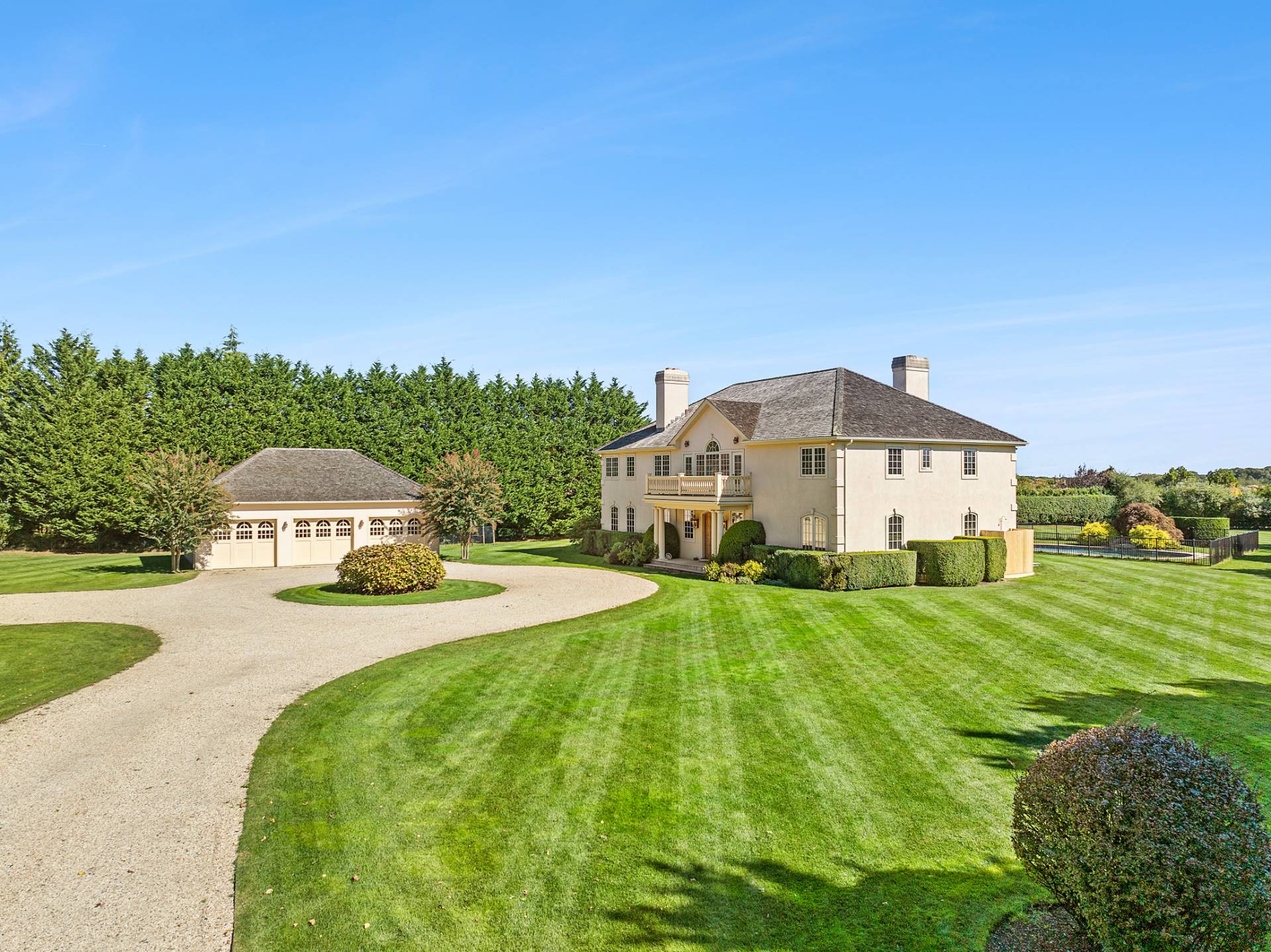 a big house with a big yard and large trees