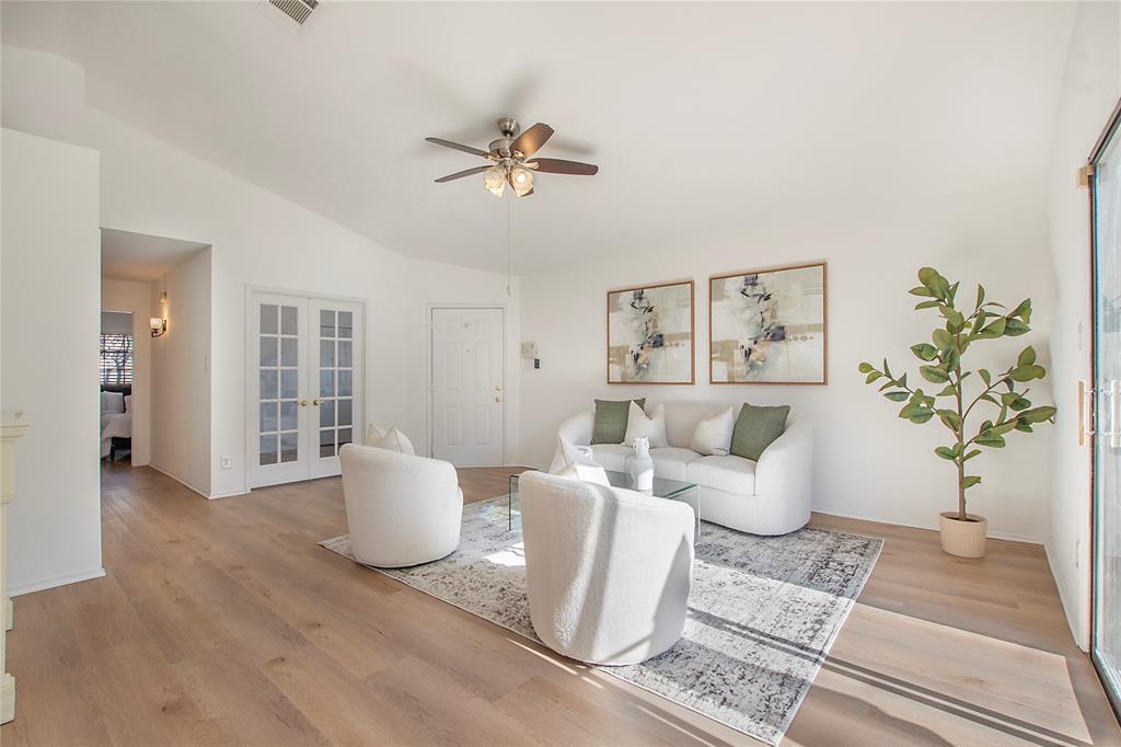 a living room with furniture and a potted plant