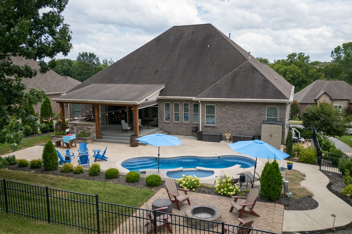 Perfect entertaining area! Heated pool and outdoor cooking area and fire pit. What a great retreat! The smaller pool above the main pool is a "tanning shelf" that is shallow.