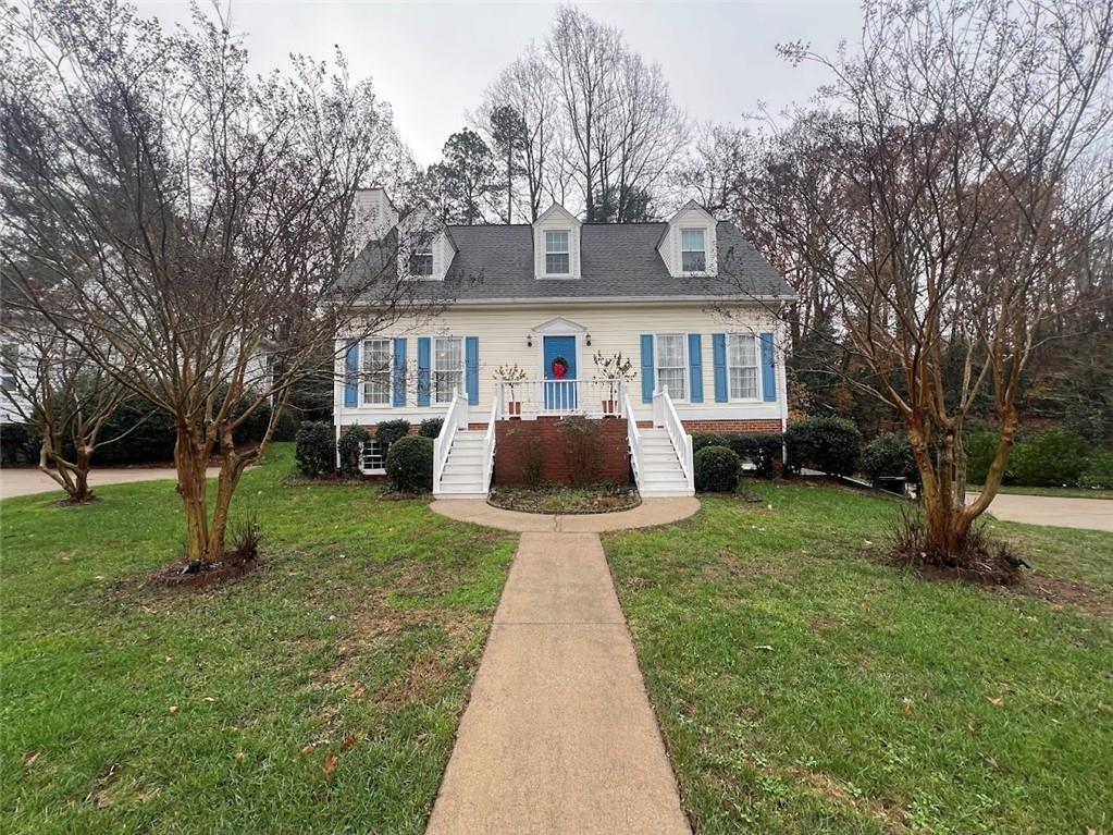 a front view of house with yard and green space