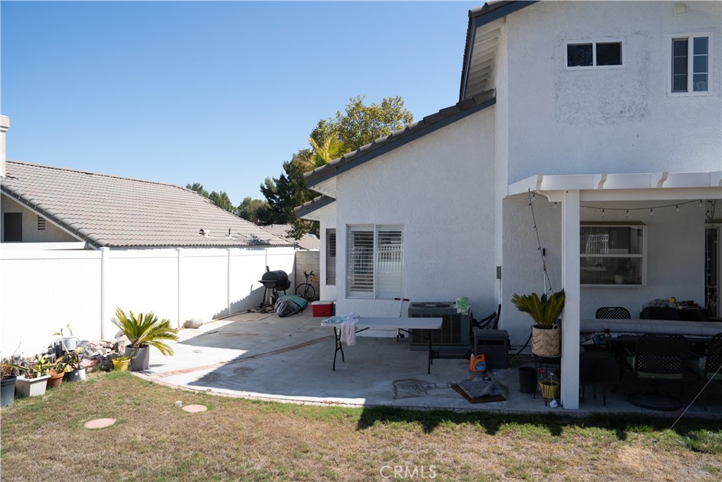 a view of a house with backyard and sitting area