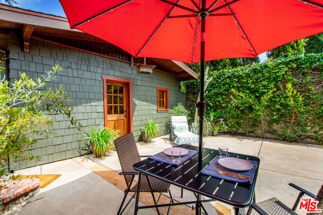 a backyard of a house with yard and outdoor seating