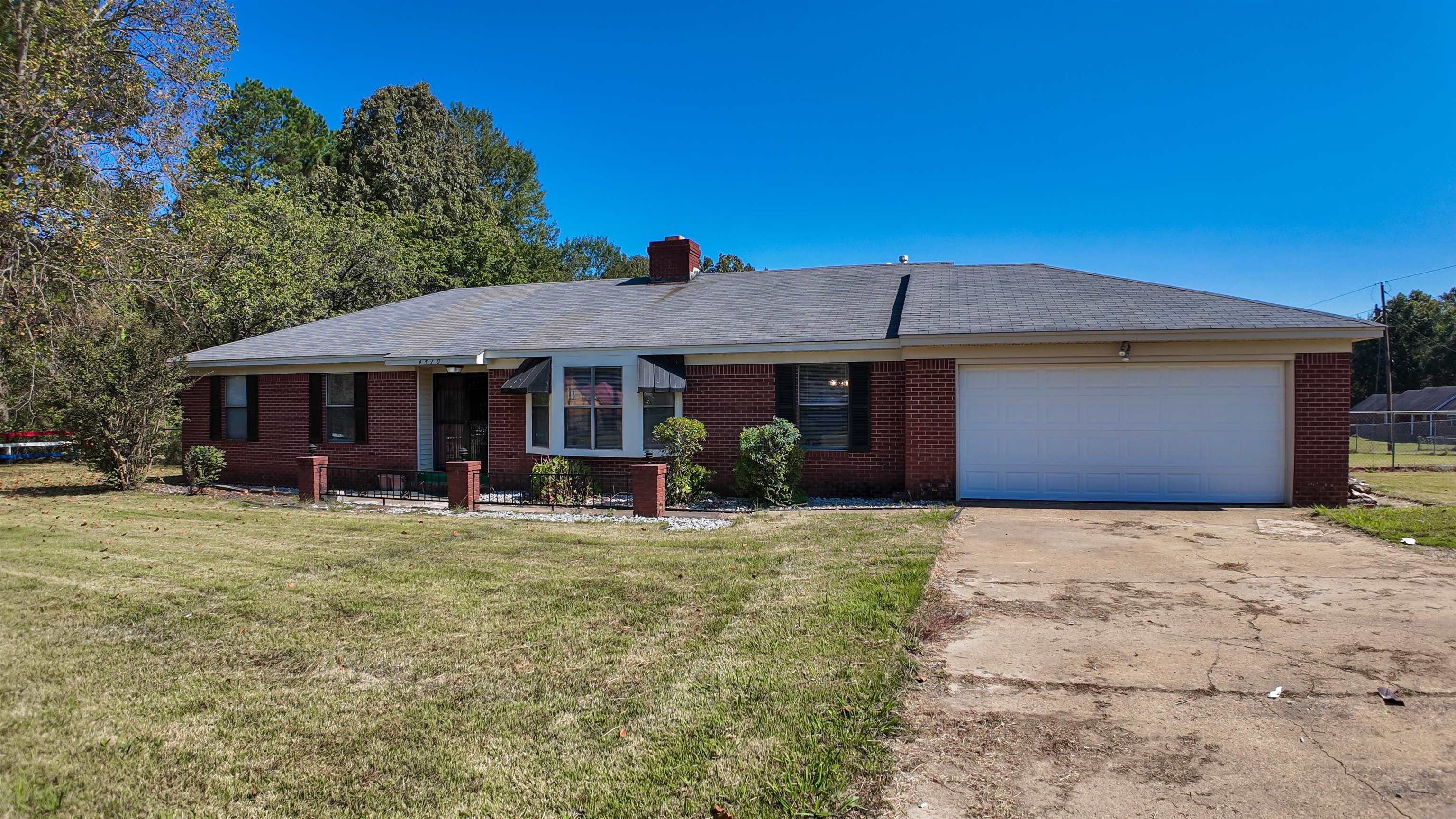 Single story home with a front yard and a garage