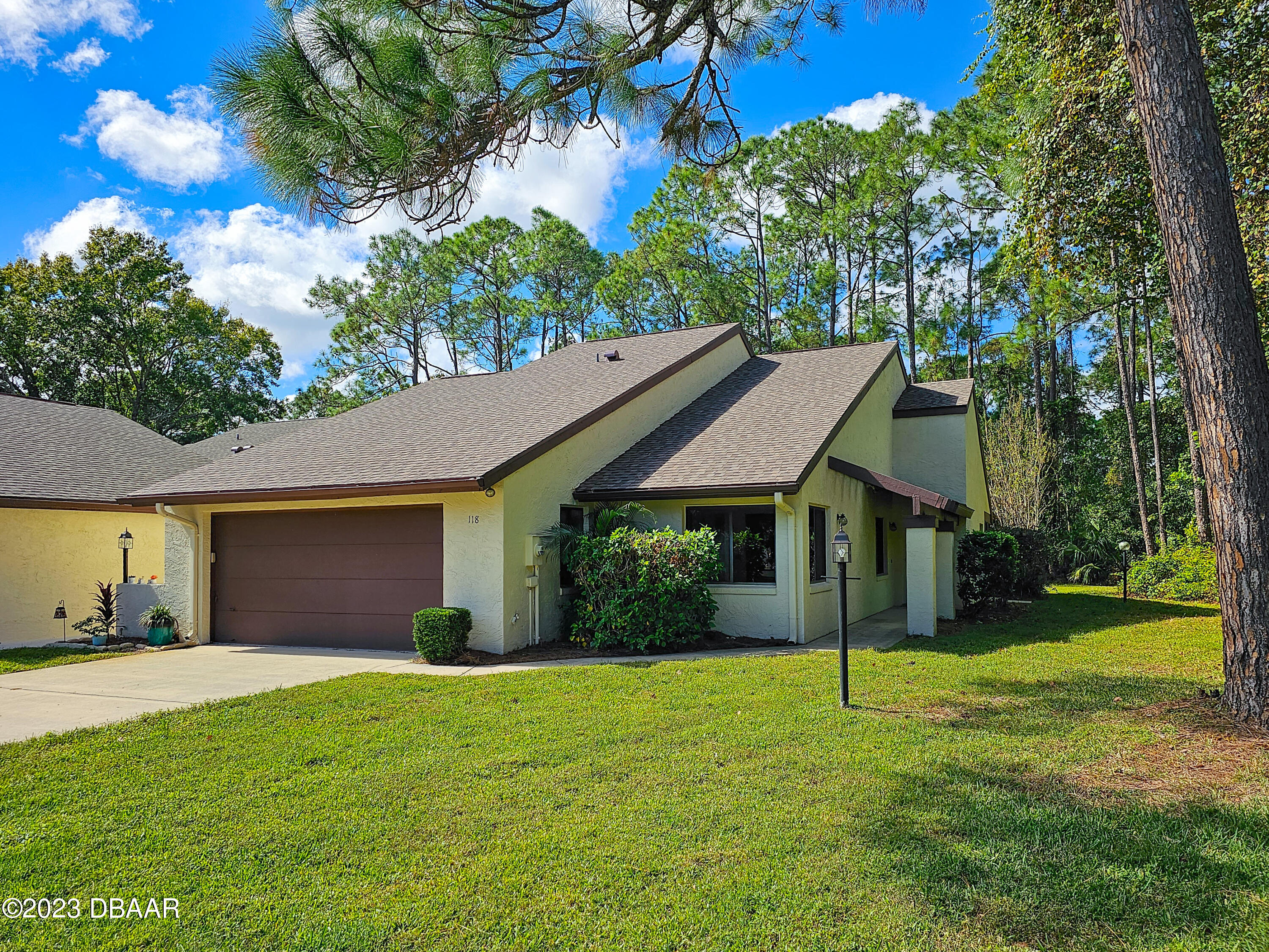 a view of a house with a yard and tree s