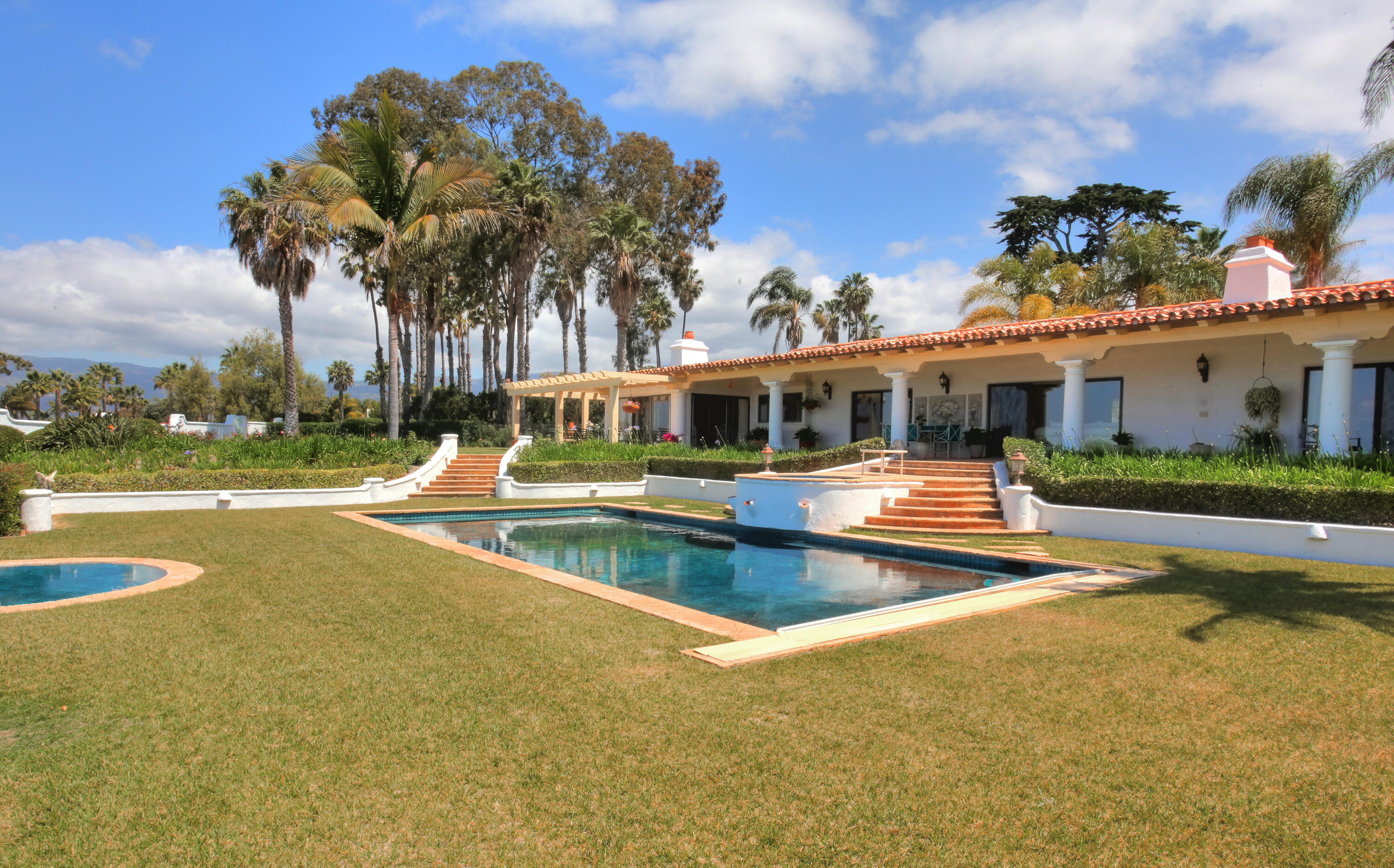 a view of a house with swimming pool and a yard