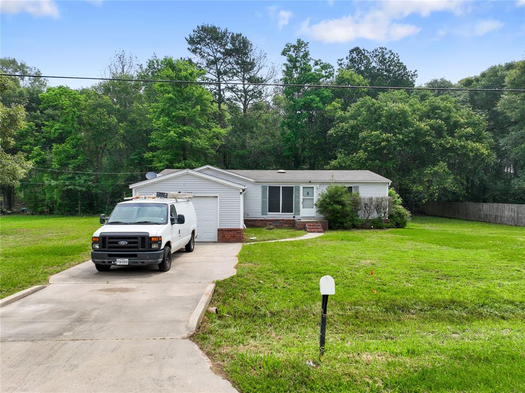 a car parked in front of a house with a yard