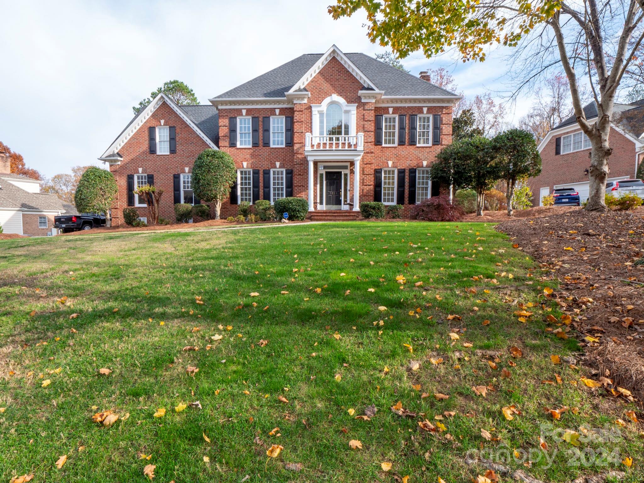 a front view of house with yard and green space