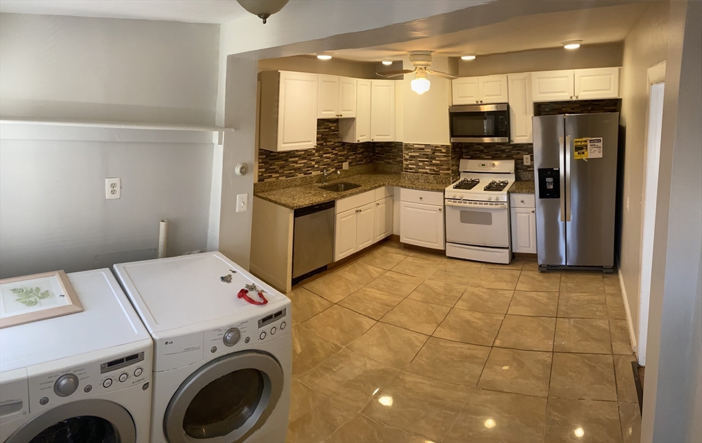 a kitchen with a sink a stove and refrigerator