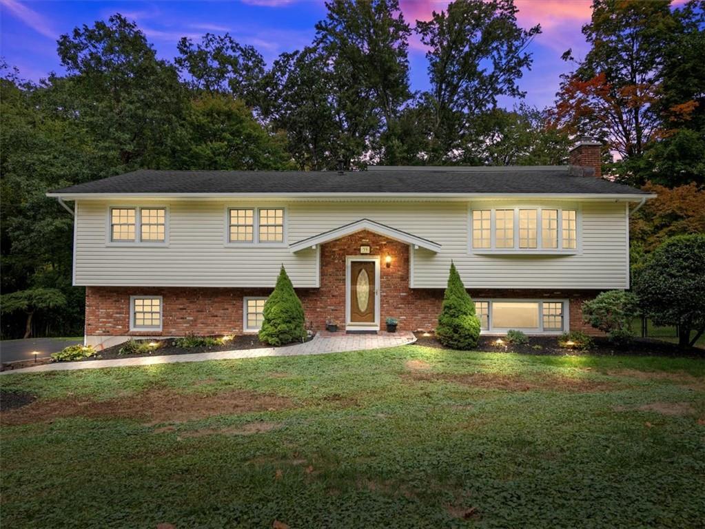 Split foyer home featuring a lawn