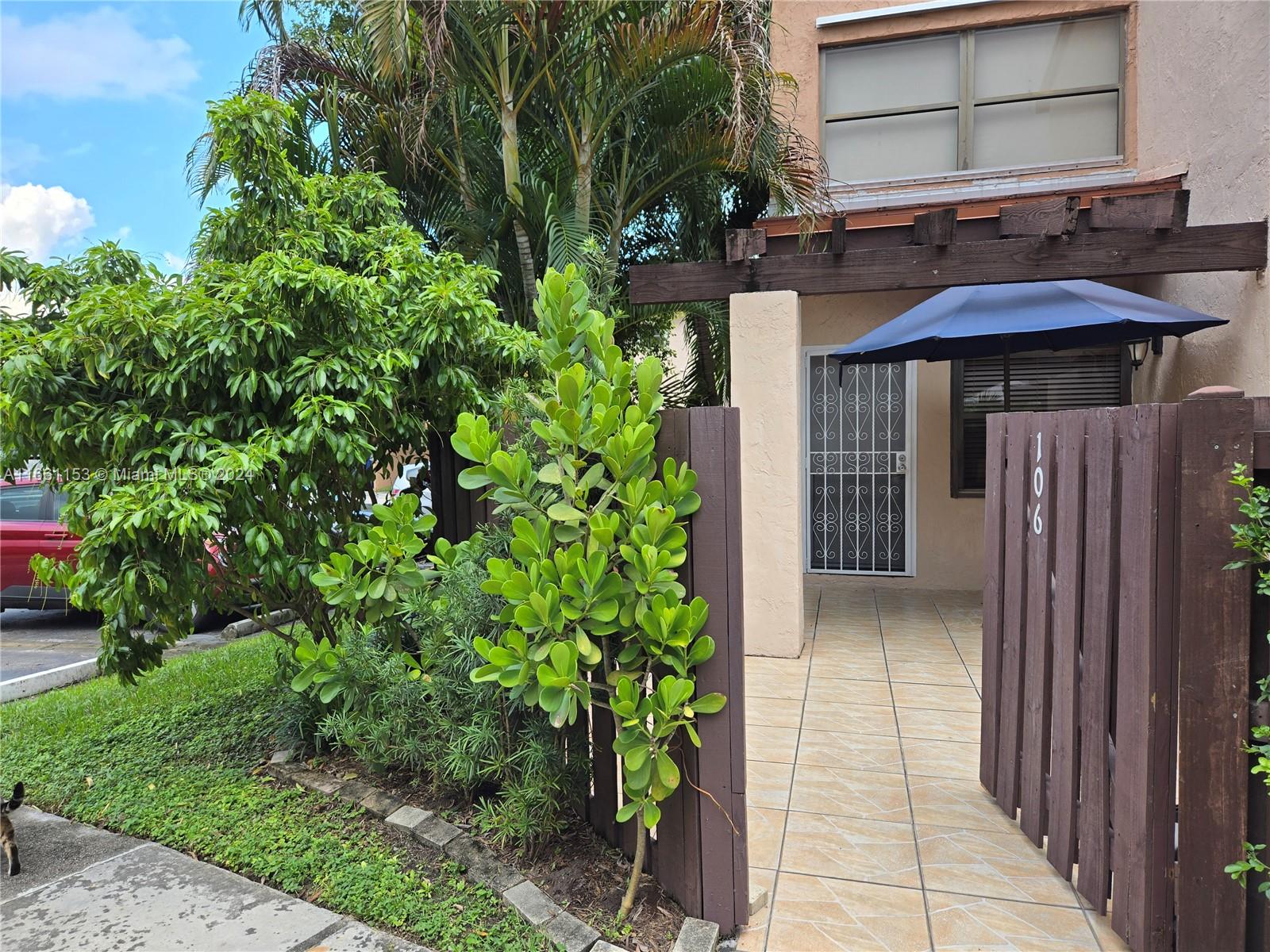 a view of a house with a small yard and plants