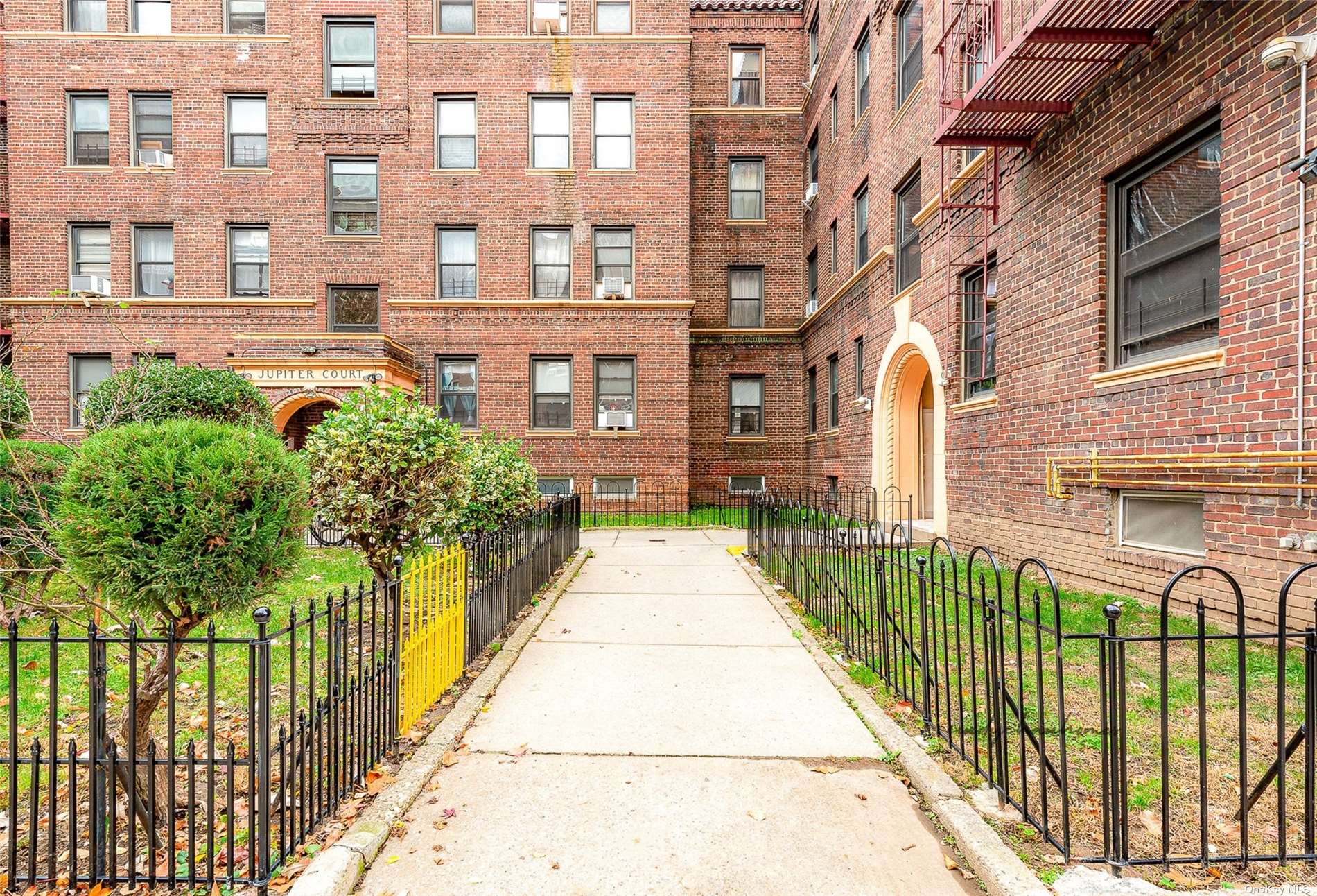 a view of a brick building next to a yard