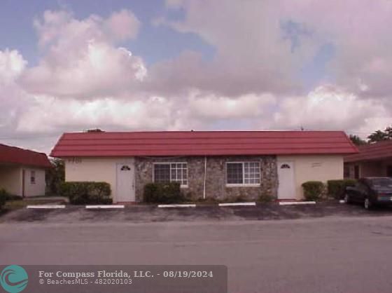 a view of a car park in front of a house