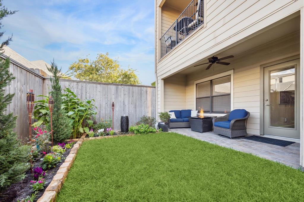 a view of a chair and table in backyard of the house