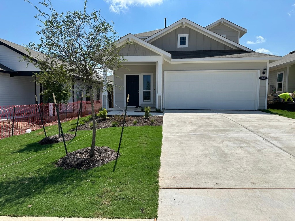 a front view of house with a garden