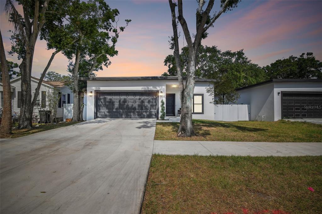 a view of a house with a yard and garage