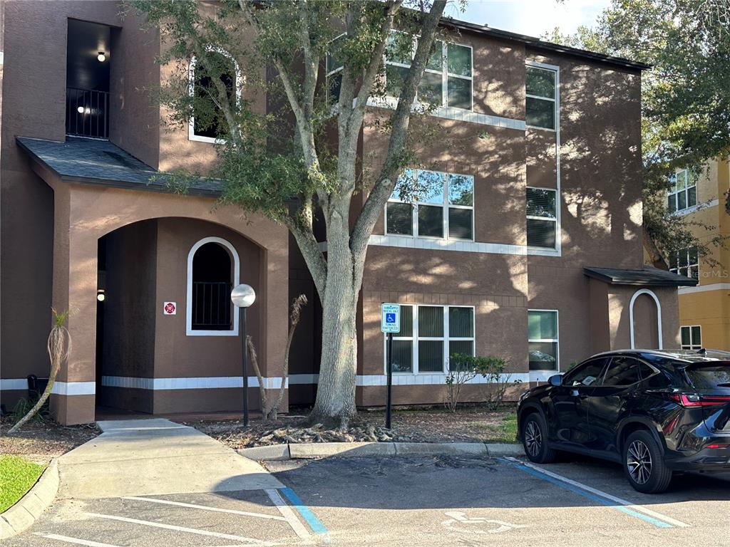 a view of a car parked in front of a brick house