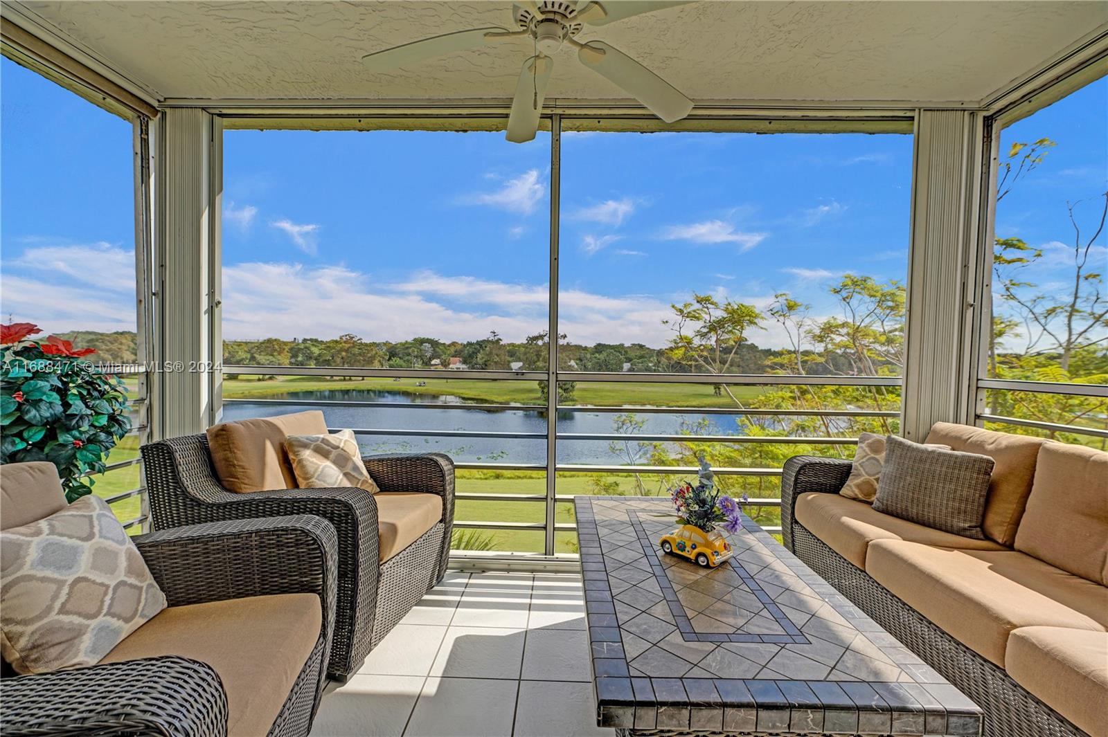 a view of swimming pool with a couches in a patio