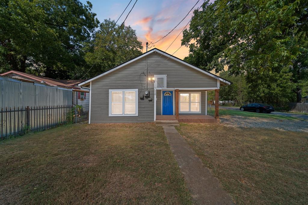 a view of a house with a yard and garage