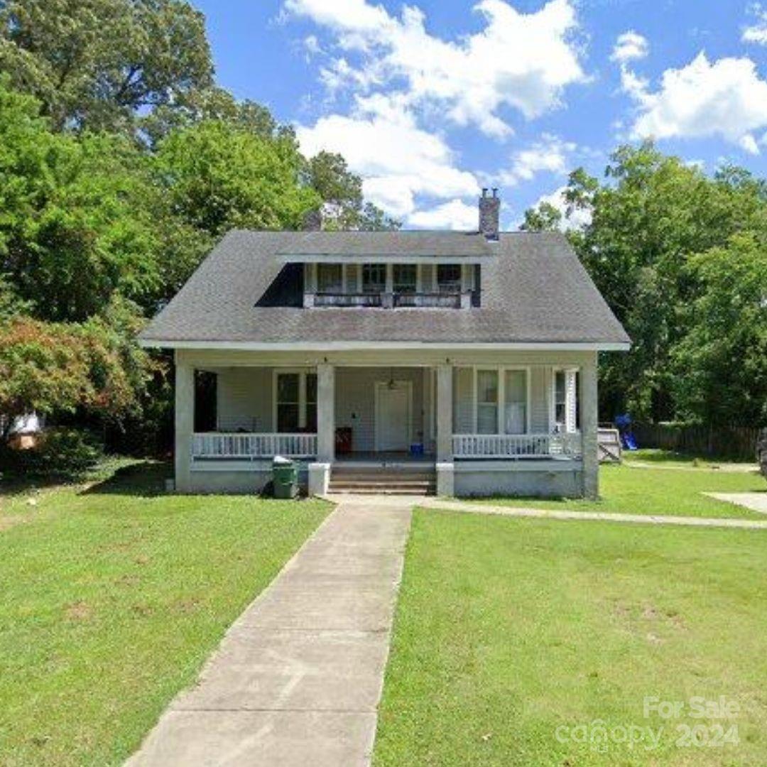 a front view of house with yard and outdoor seating