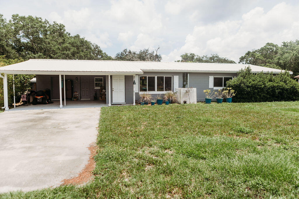 a view of a house with backyard porch and sitting area