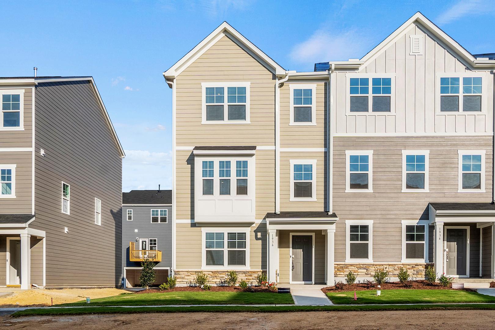 a front view of a residential apartment building with a yard