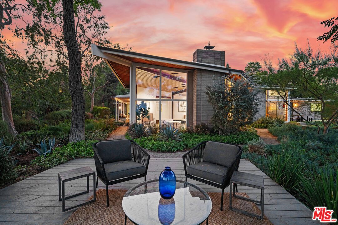 a view of a patio with couches chairs and a potted plant