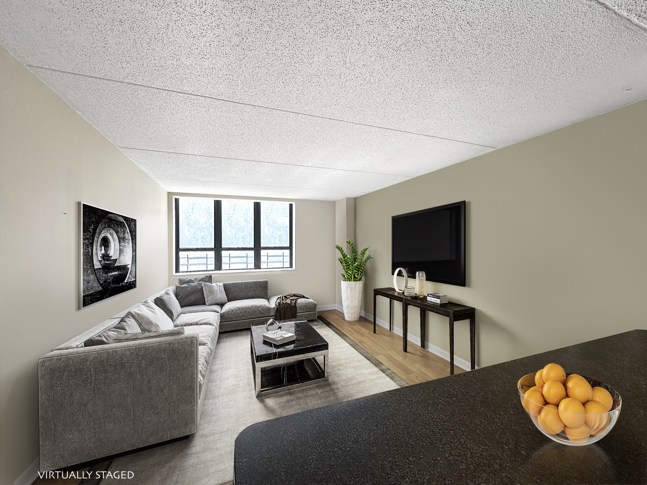 a living room with furniture a flat screen tv and a window