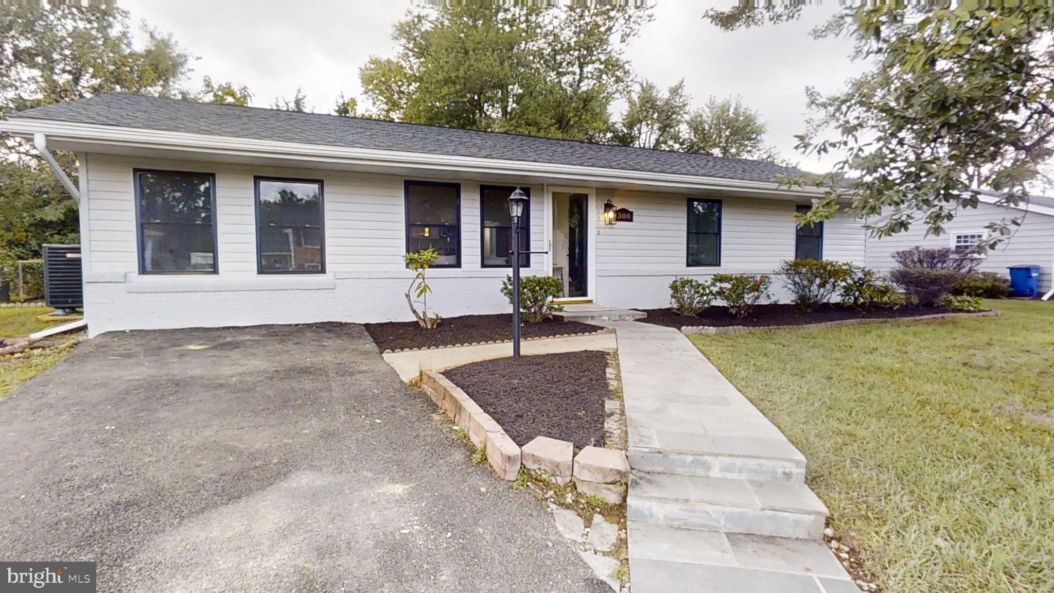 a front view of a house with a garden and patio