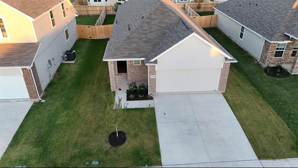 an aerial view of a house with a yard