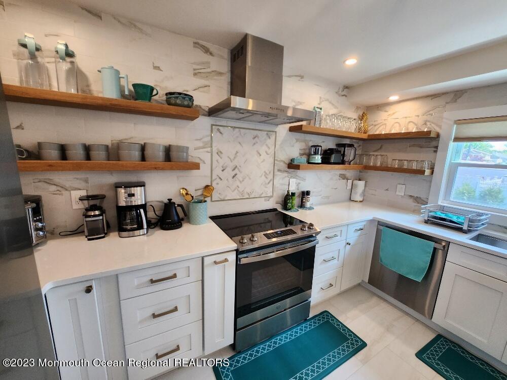 a kitchen with stainless steel appliances granite countertop a stove and a sink