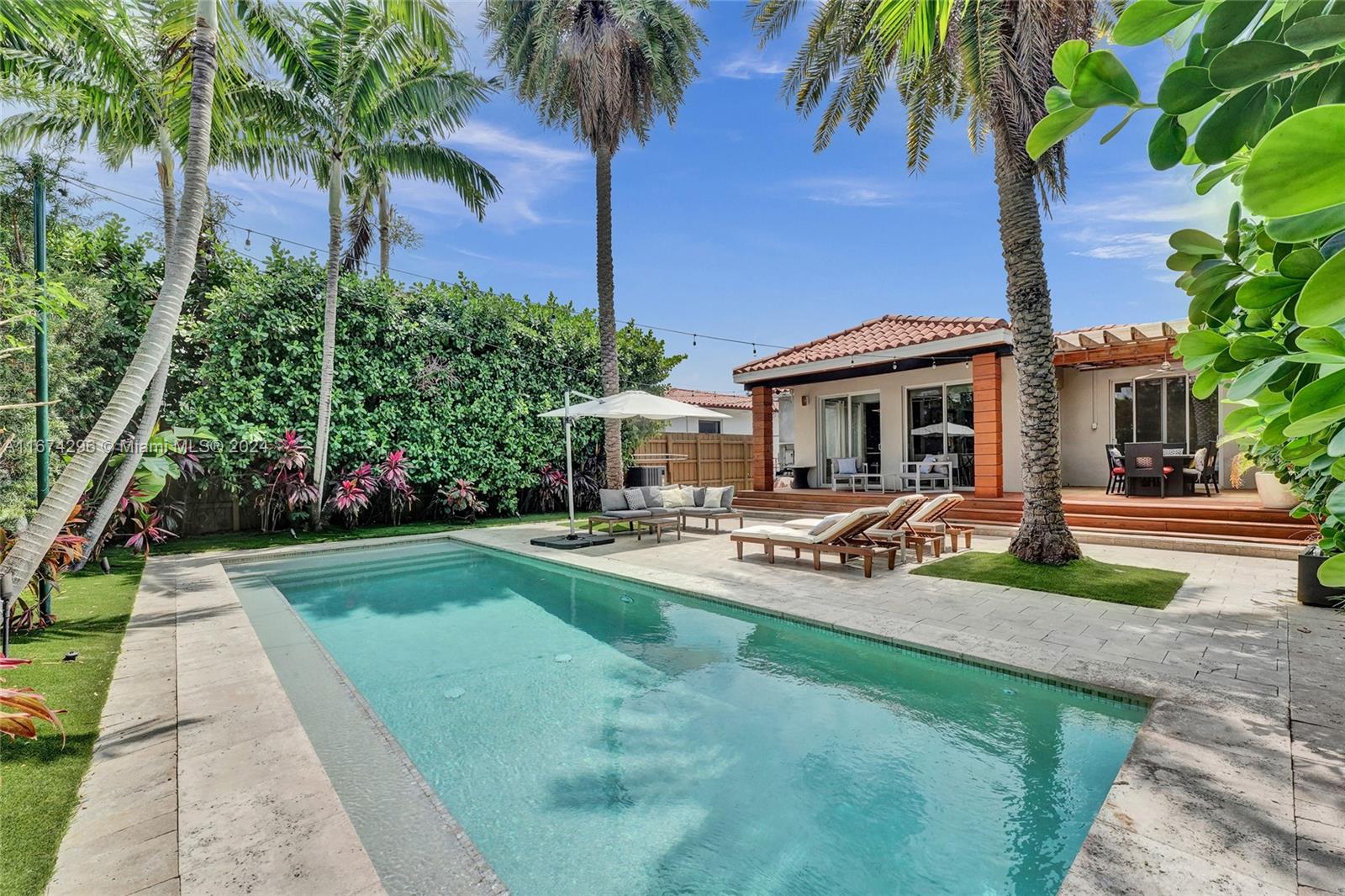 a front view of a house with garden and swimming pool