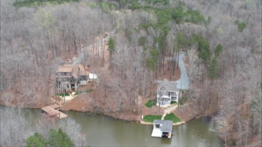 a swimming pool view with a lake view