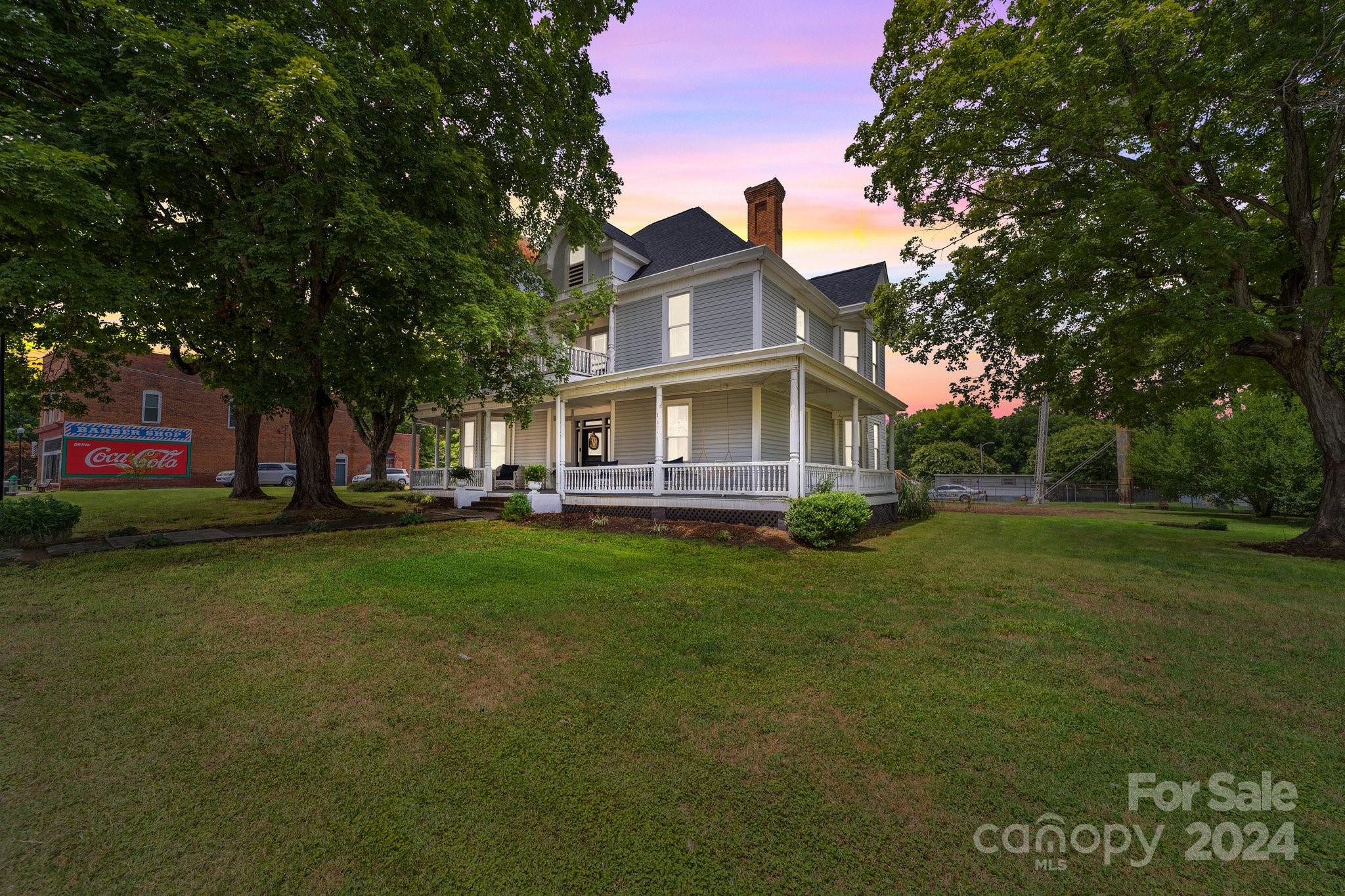 a view of house with outdoor space and garden