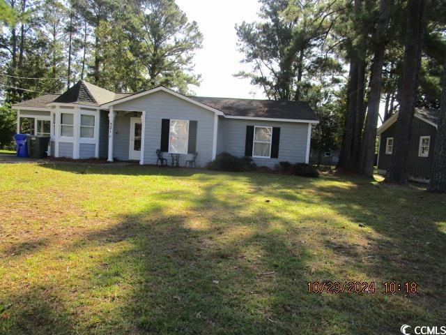 Ranch-style house featuring a front lawn