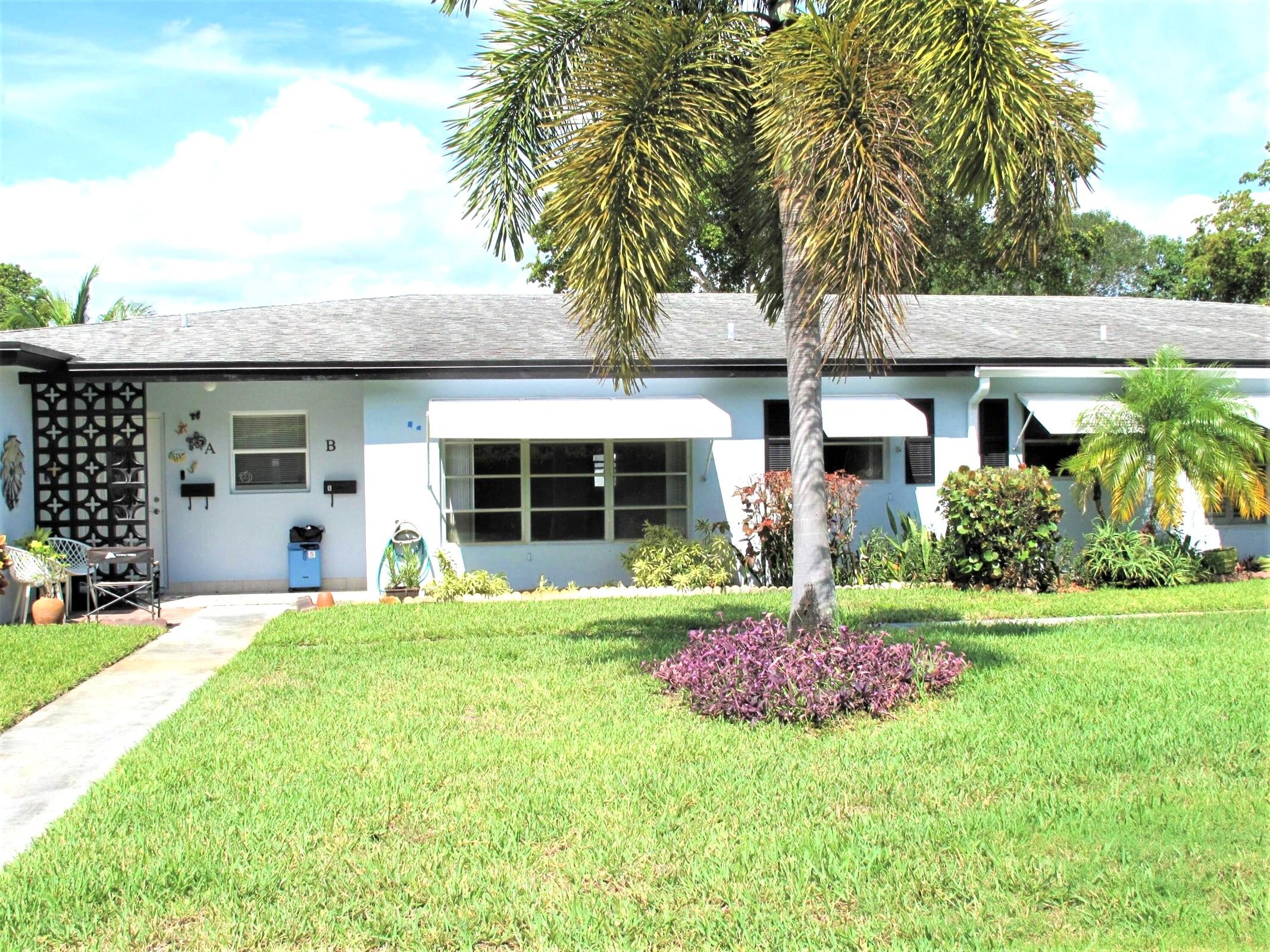 a front view of a house with a garden and porch