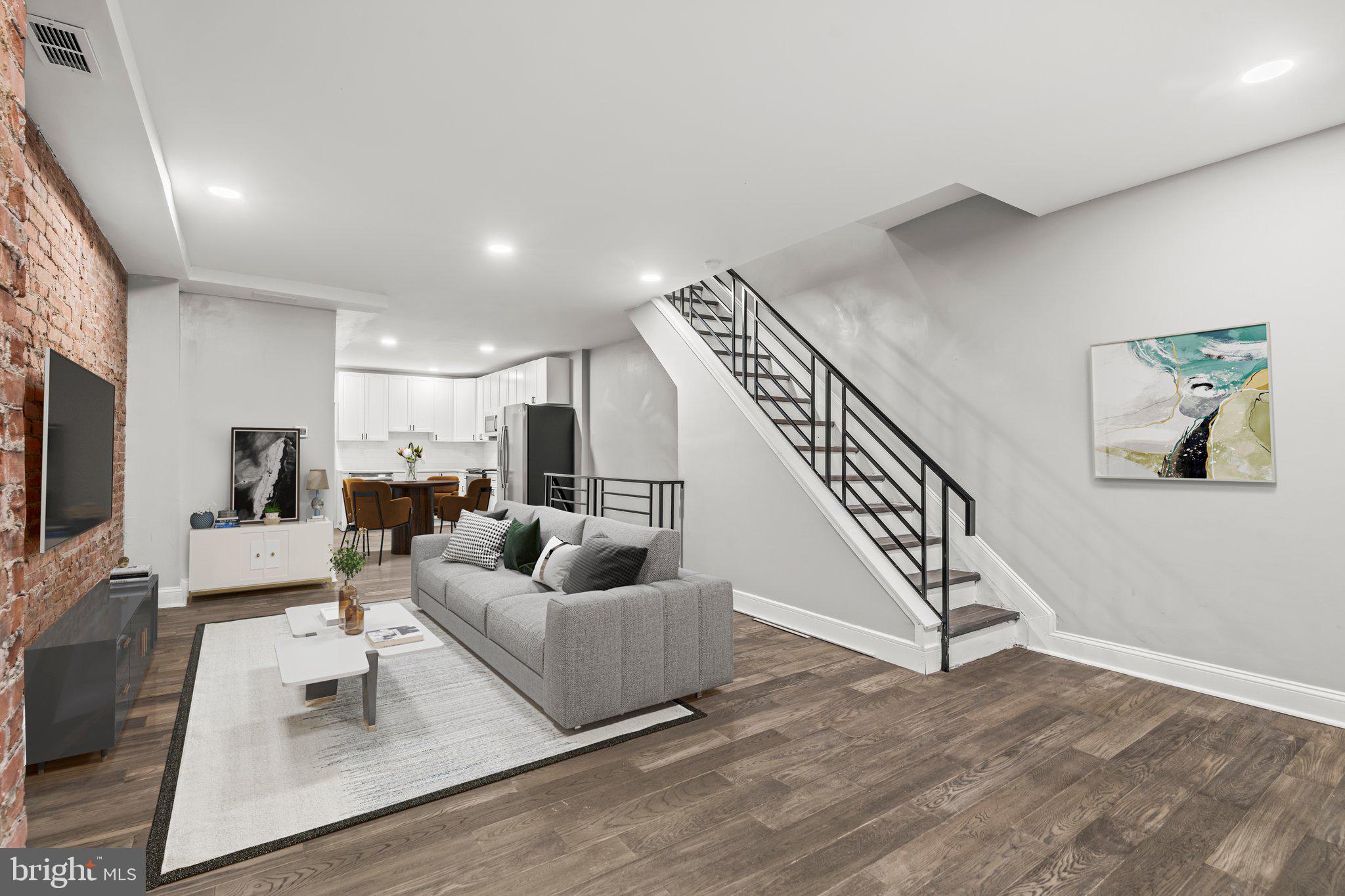 a living room with furniture and a flat screen tv