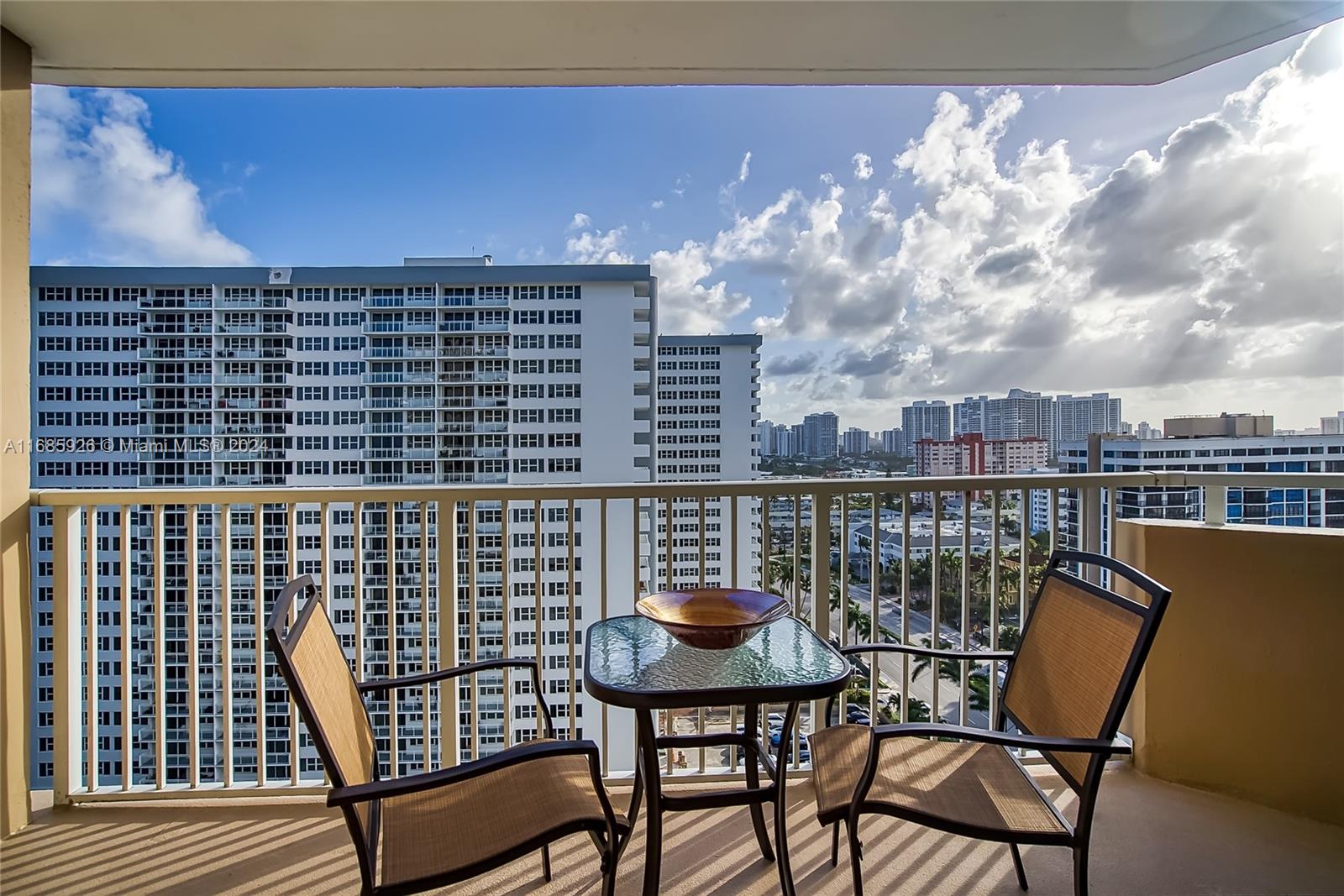 a balcony with table and chairs